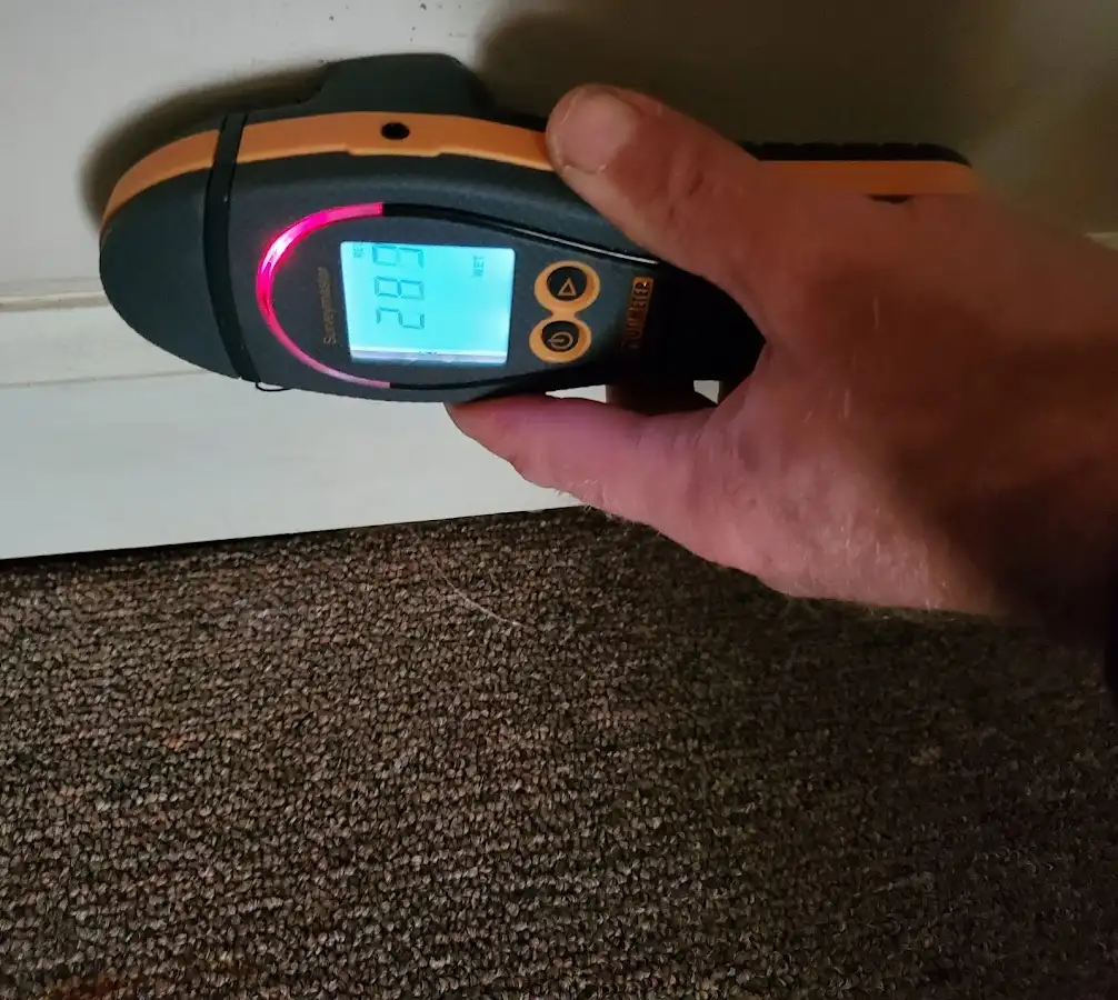 Moisture detection at baseboard during Storm Damage Restoration in Portland